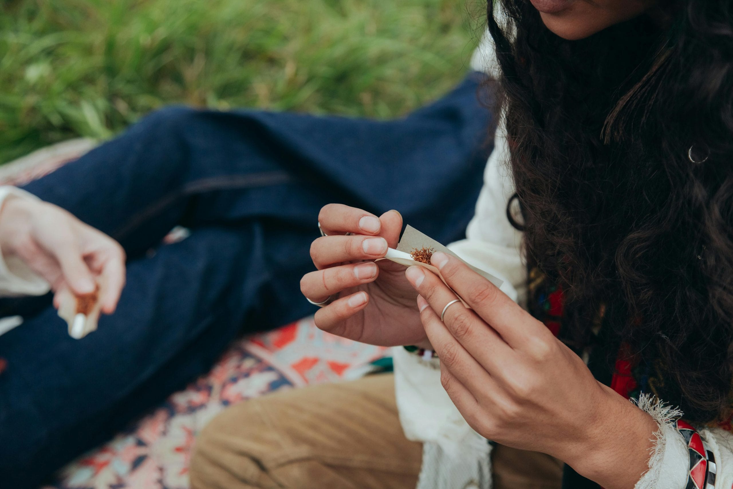 A person rolling a joint. 