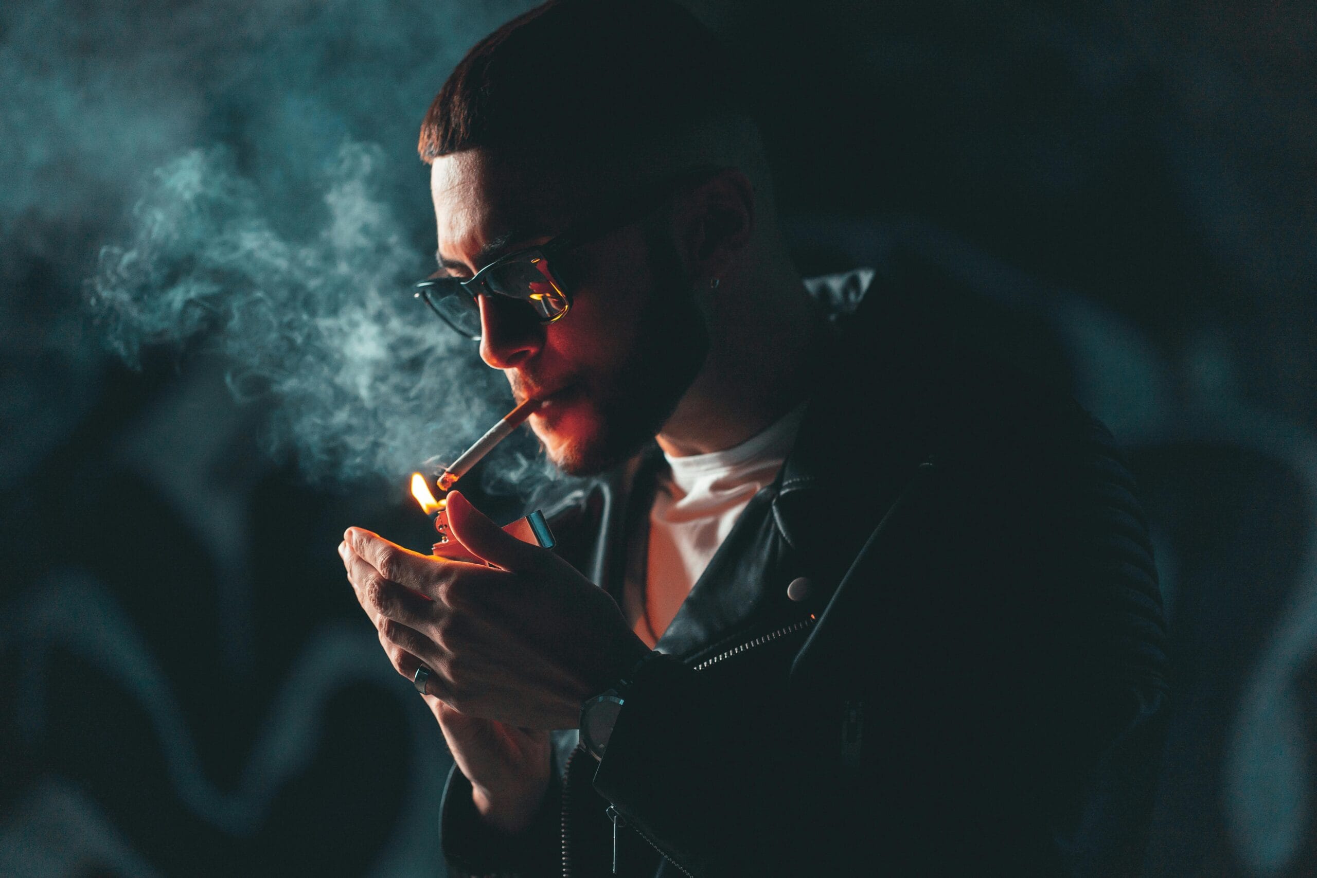 Close-Up Shot of a Man in Black Leather Jacket Smoking