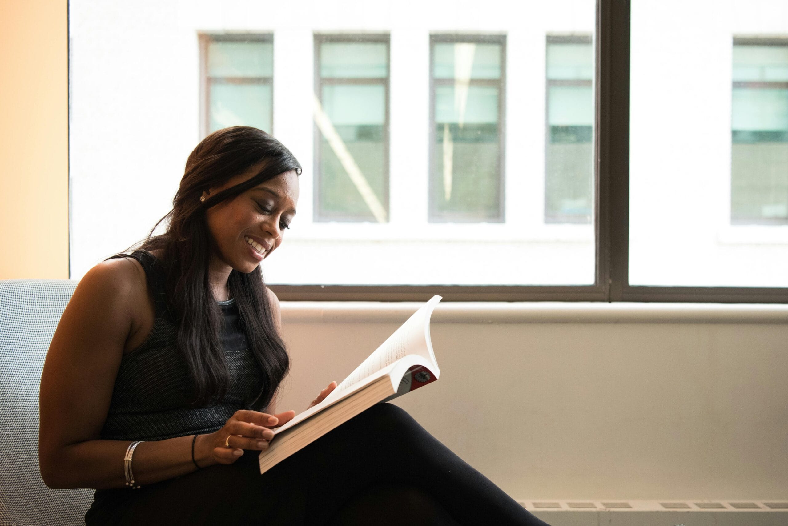 A woman reading one of the sobriety books for women