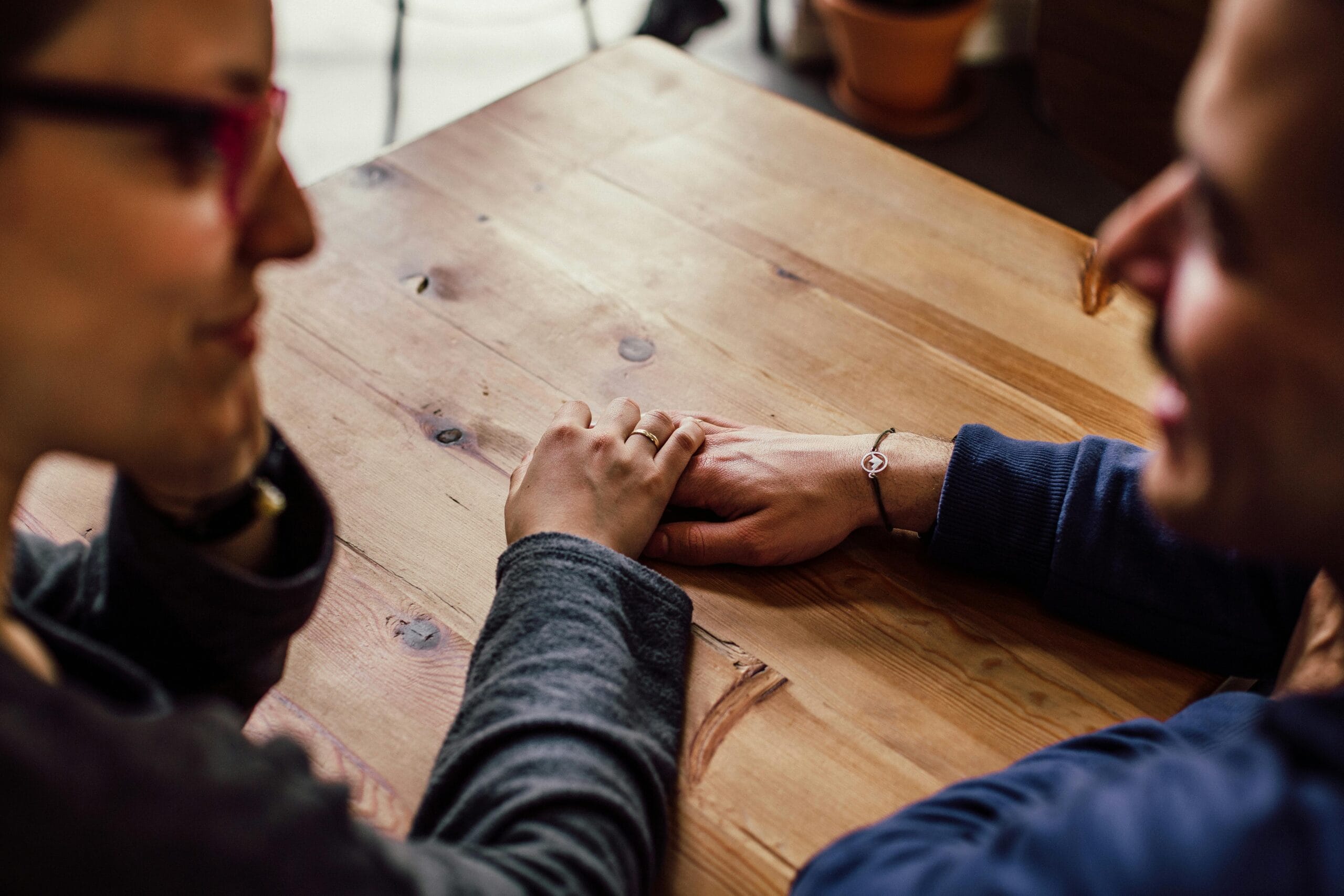 A couple holding hands in support. 