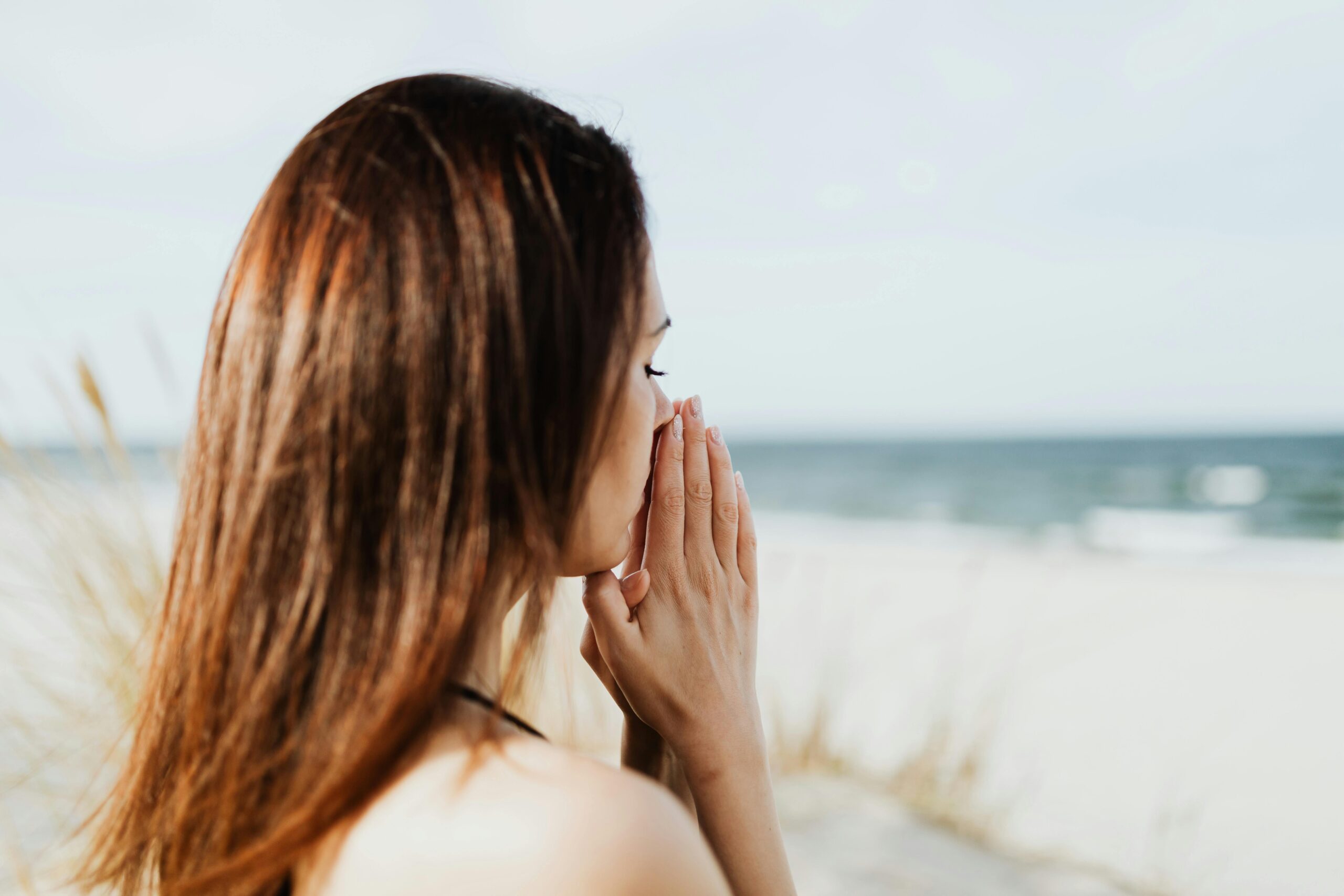 A woman meditating on the beach