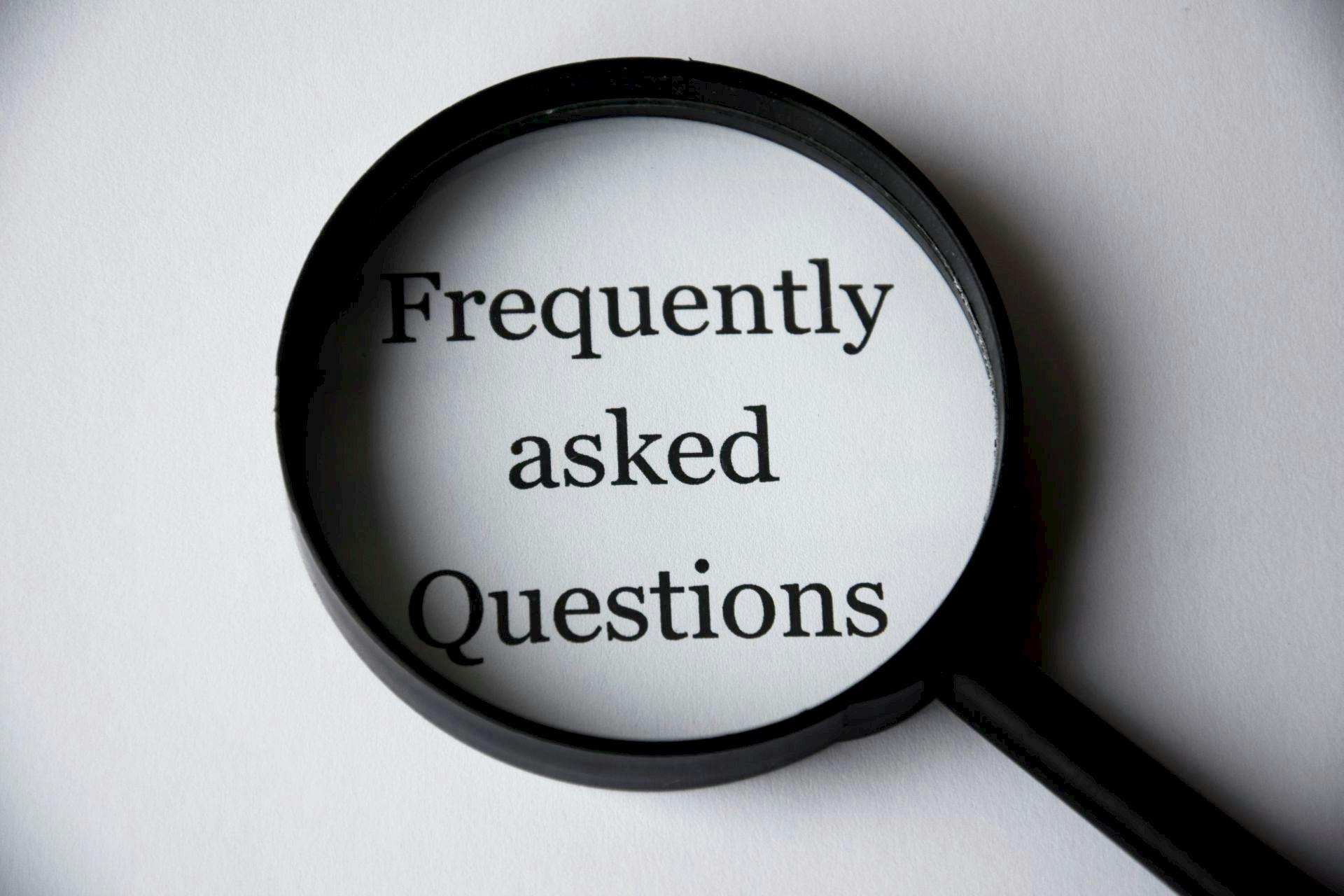 Phrase ¨Frequently asked questions¨under magnifying glass