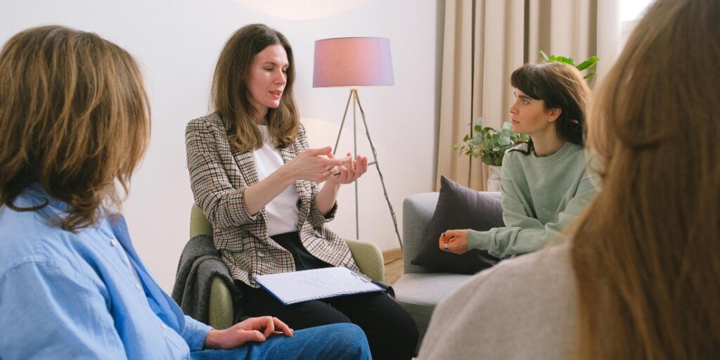 A group therapy session in progress, providing support for individuals overcoming alcoholism, a crucial step in treating alcohol use disorder.