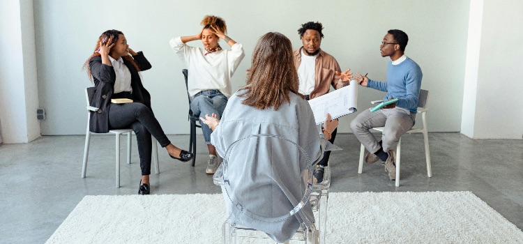 Group therapy session illustrating individuals learning and practicing healthy coping mechanisms together.