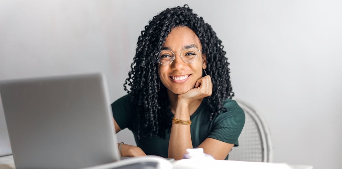 A happy woman using a laptop
