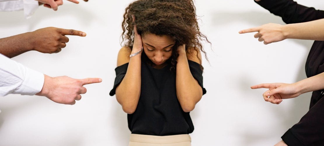 Many fingers pointed accusingly at a woman