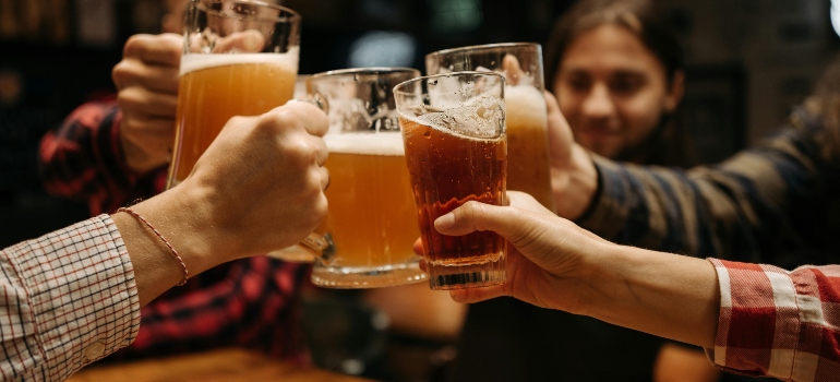 toasting with four glasses of beer