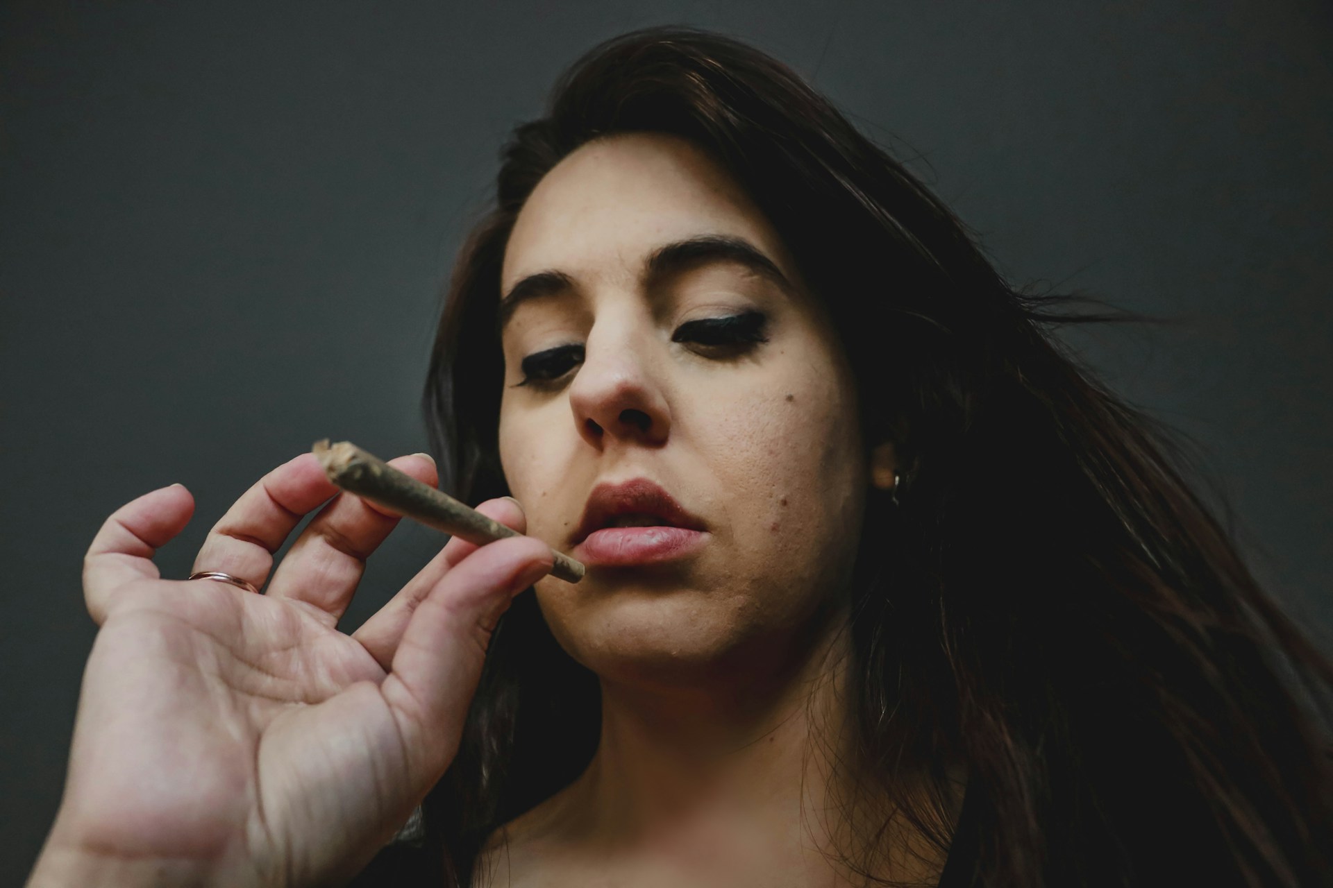woman smoking and thinking about drug rehab success rates and statistics