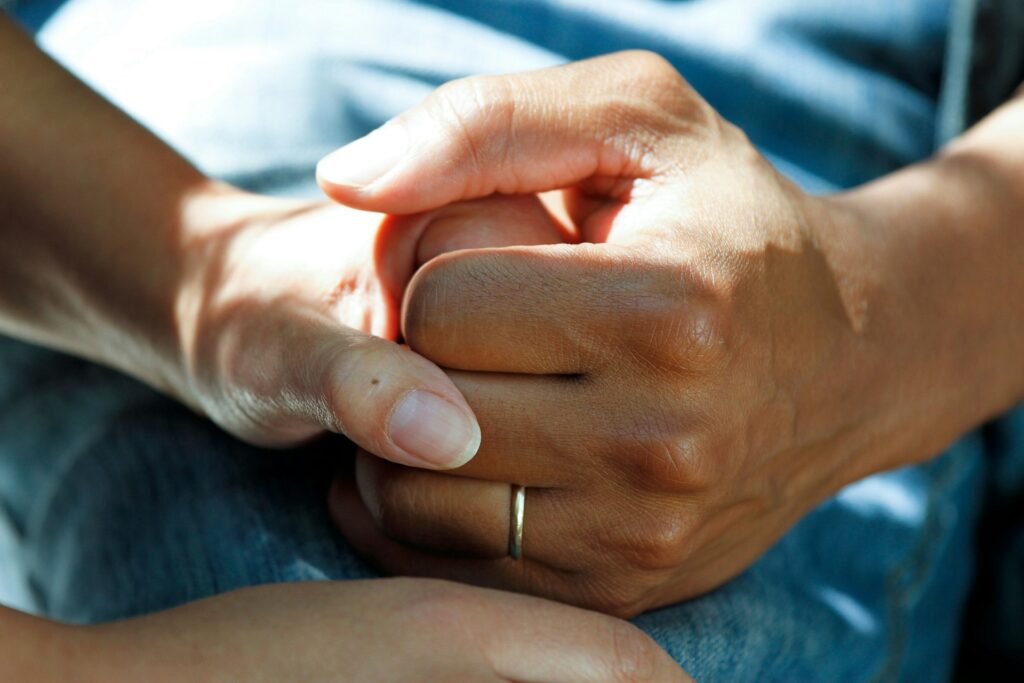 holding hands with a patient