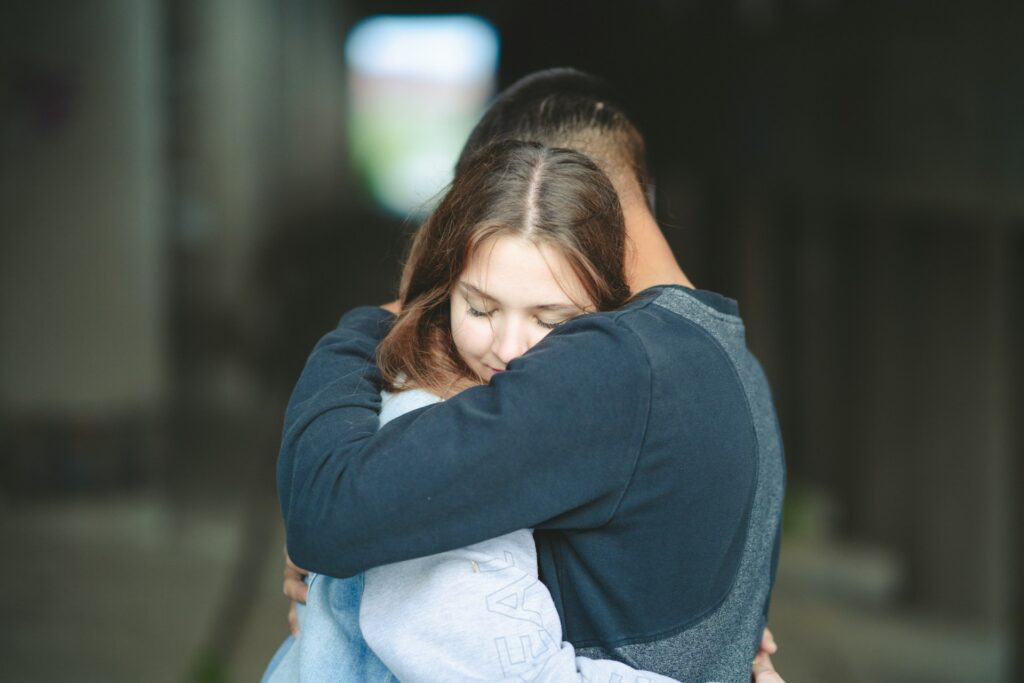 couple talking about family therapy in addiction treatment while hugging