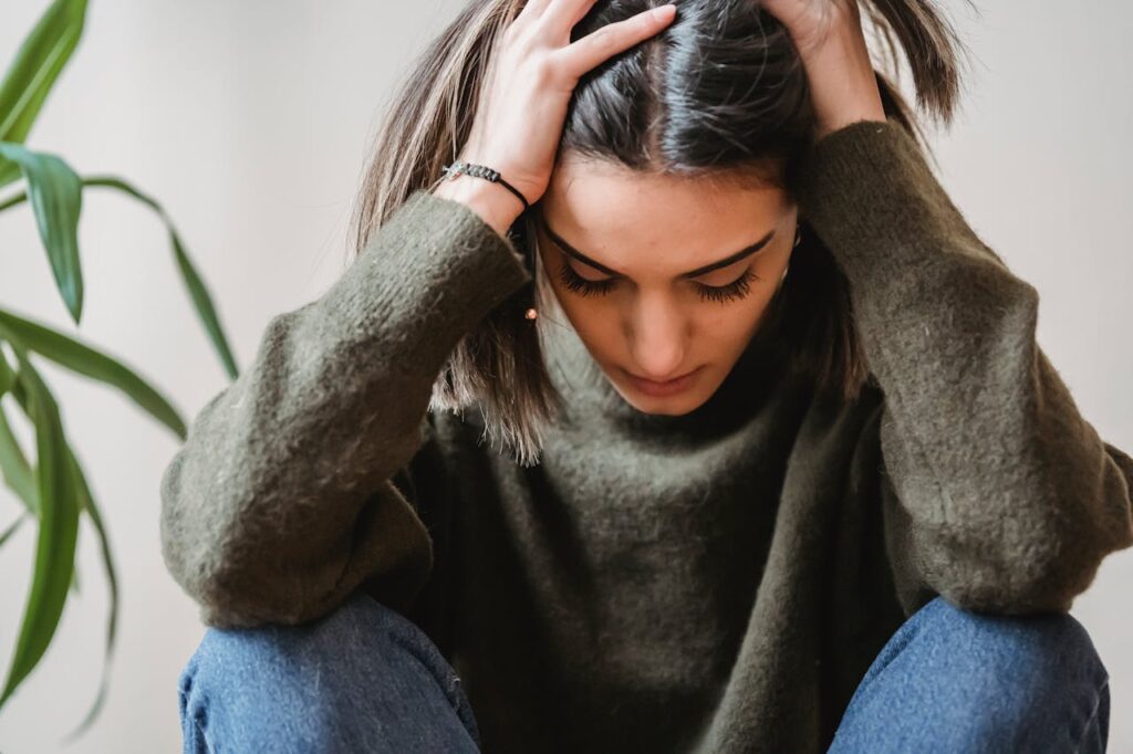 young woman holding her head