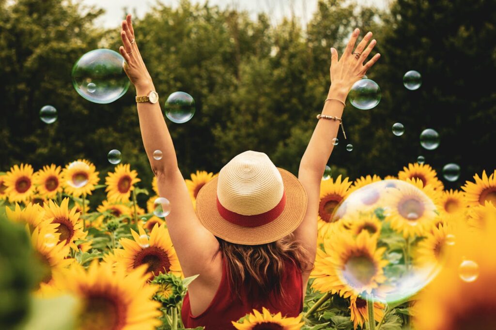 happy woman in a sunflower field after breaking out from depression and addiction